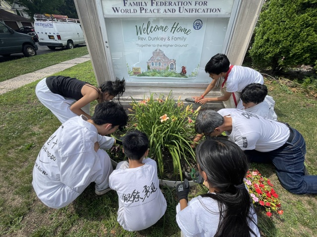 Planting Together — Working side by side in the flower bed — responsibility, cooperation, and care f