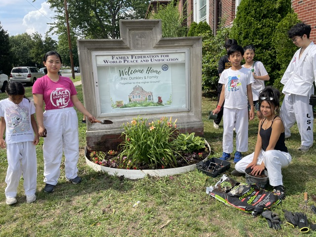 Service Project — Students at the Clifton Family Church sign for the flower-planting service proje