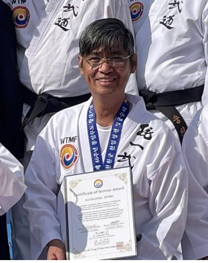 Master Nathaniel Nitro holding his World Martial Arts Federation for World Peace Certificate of Service Award